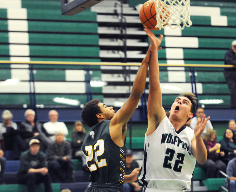 Glacier's Xavier Pace is fouled by C.M. Russell's John Learn while going up for a shot during the first quarter at Glacier on Friday. (Aaric Bryan/Daily Inter Lake)