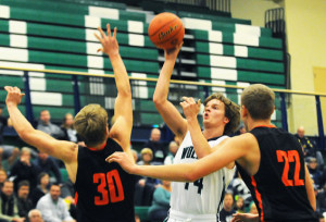  Glacier's Noah Lindsay puts up a shot over Frenchtown's Andrew King (30) and Austin Means (22) during the first quarter on Friday. (Aaric Bryan/Daily Inter Lake)