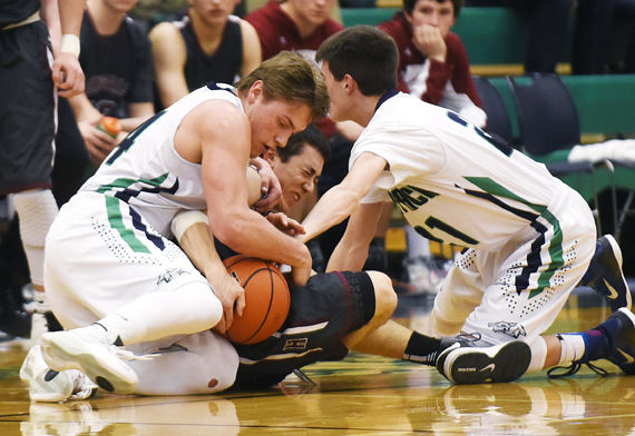 Glacier's Tadan Gilman and Dylan Ruggles Glacier's Tadan Gilman, left, and Dylan Ruggles tie up Helena's Connor Matthews for a held ball during the third quarter of the Wolfpack's 37-36 victory at Glacier on Friday. (Aaric Bryan/Daily Inter Lake) 
