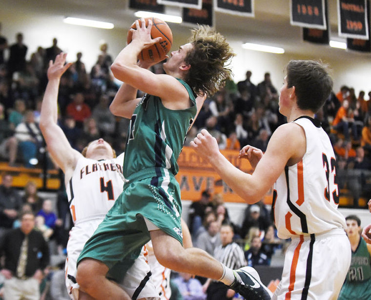 Glacier's Noah Lindsay crashes into Flathead's Seth Adolph (4) as Sam Elliott (33) looks on during the Wolfpack's 52-37 win at Flathead on Tuesday. Lindsay was called for an offensive foul on the play. (Aaric Bryan/Daily Inter Lake)