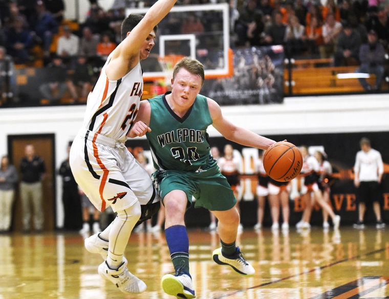 Glacier's Jake Willich is fouled by Flathead's C.J. Dugan during the Wolfpack's 52-37 in the state play-in game at Flathead on Tuesday. (Aaric Bryan/Daily Inter Lake)