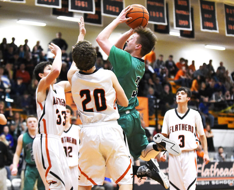 Glacier's Blayne Bailey shoots over Flathead's Bridger Johnson during the Wolfpack's 52-37 win in the state play-in game at Flathead on Tuesday. (Aaric Bryan/Daily Inter Lake)