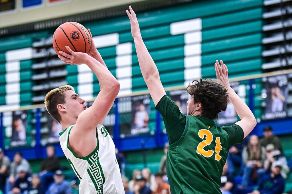 Glacier's Asher Knopik (11) shoots guarded by Great Falls CMR's Brady Pike (21) in the third quarter at Glacier High School on Friday, Dec. 13. (Casey Kreider/Daily Inter Lake)